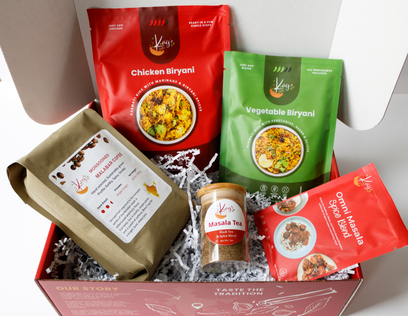 Food Lover Gift Box with Chicken Biryani, Vegetable Biryani, Masala Tea, Omni Masala, and Indian coffee in a red gift box