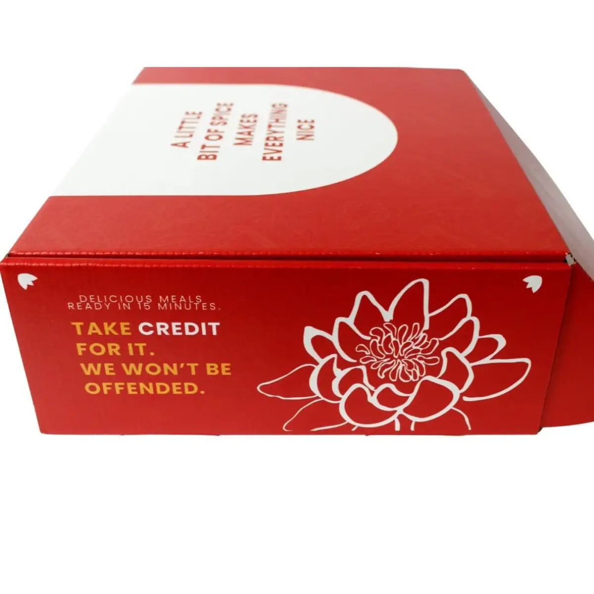 A red cardboard food delivery box with white and yellow printed text and a white floral line drawing, photographed on a plain white background.