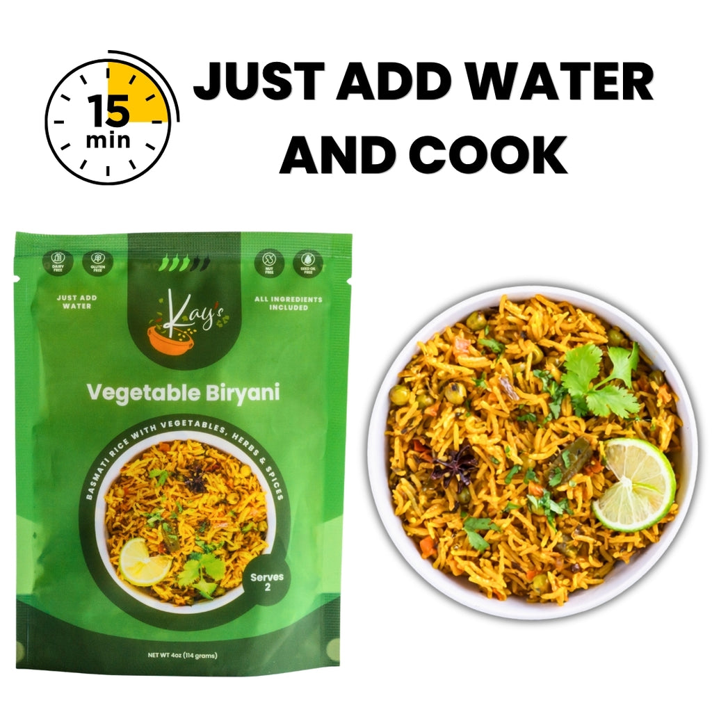 A green pouch of Kay's Vegetable Biryani shown next to a white bowl filled with cooked biryani rice garnished with cilantro and a lime wedge. Large text at the top reads 'JUST ADD WATER AND COOK' with a 15-minute icon.