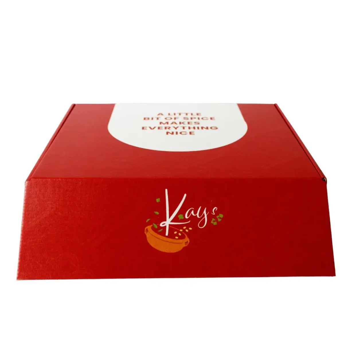 A red cardboard gift box with a white label on top reading 'A LITTLE BIT OF SPICE MAKES EVERYTHING NICE' and the brand name 'Kays' printed on the front with a small orange bowl graphic, shown on a white background.