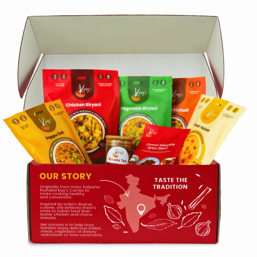 Kay's Curries Complete Collection in a red gift box with Chicken Biryani, Vegetable Biryani, Masala Kichadi, Pappu Dal, Kesar Halwa, Omni-Masala and Masala Tea
