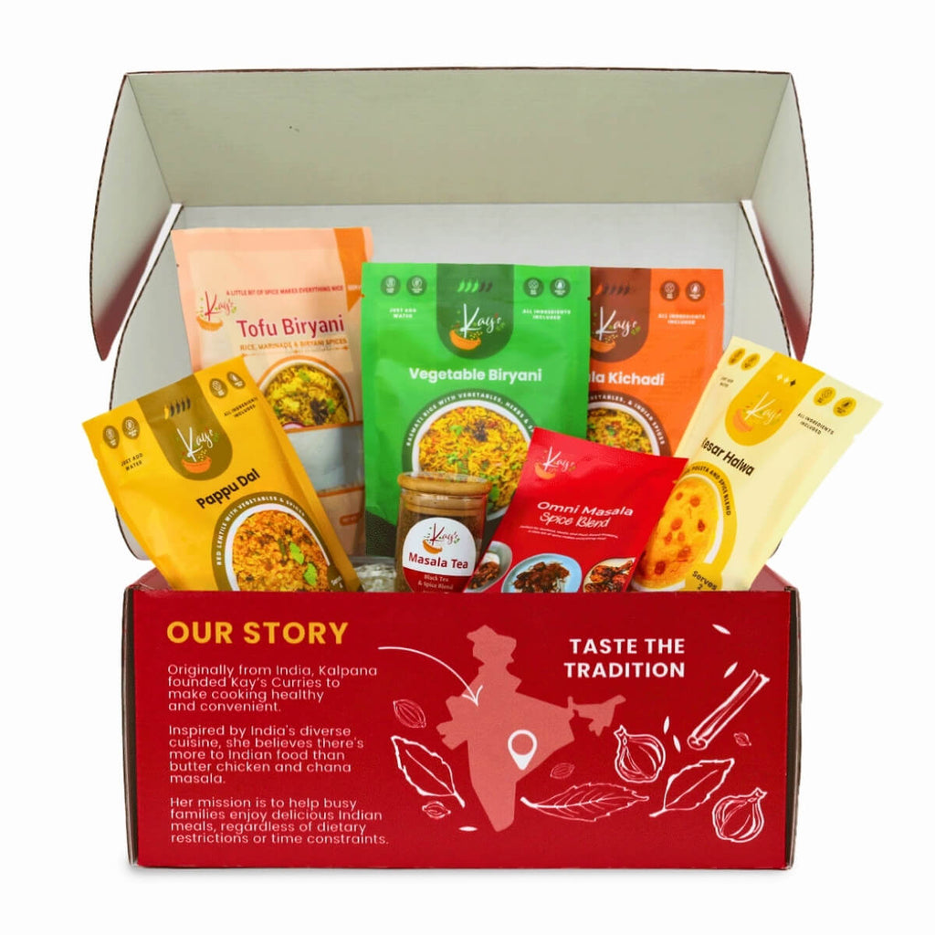 Kay's Curries Complete Collection in a red gift box with Tofu Biryani, Vegetable Biryani, Masala Kichadi, Pappu Dal, Kesar Halwa, Omni-Masala and Masala Tea