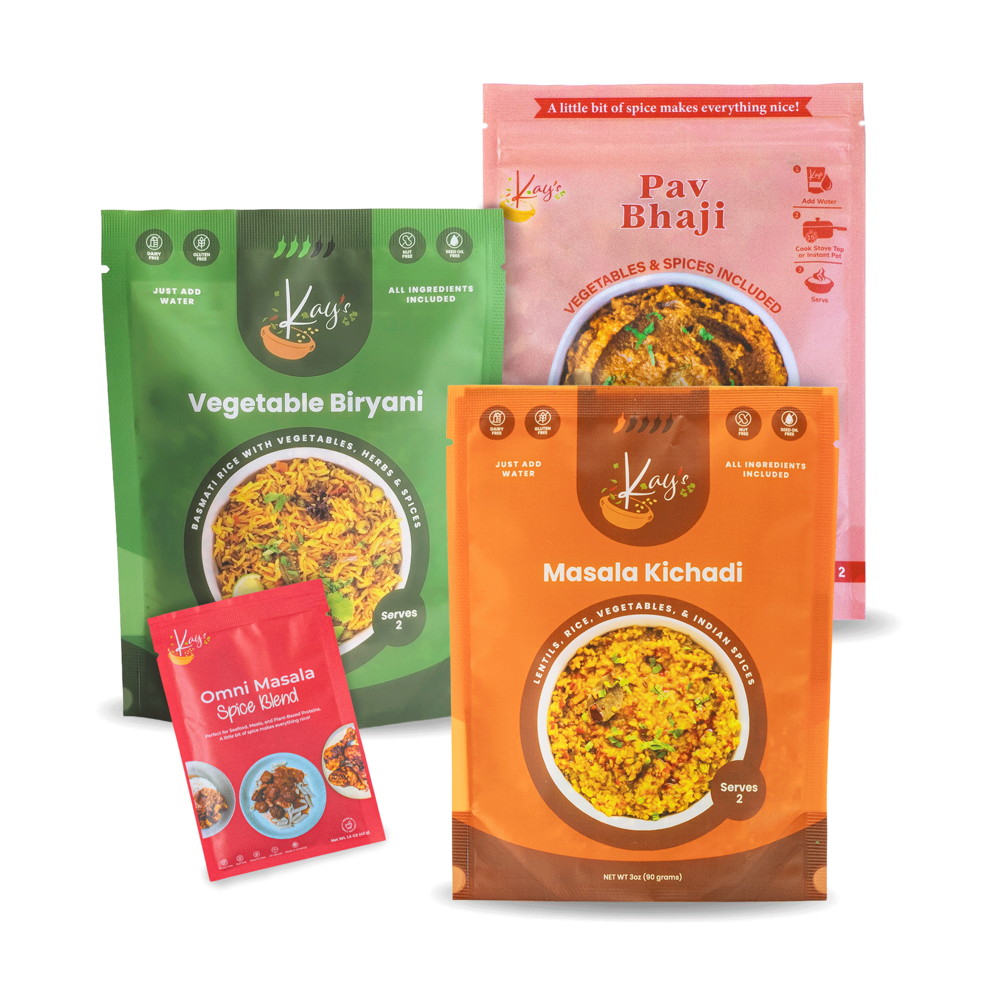 Three stand-up pouches of Kay's Curries products on a white background: a green Vegetable Biryani pouch, an orange Masala Kichadi pouch, and a pink Pay Bhaji pouch, with a small red Omni Masala Spice Blend packet in front.
